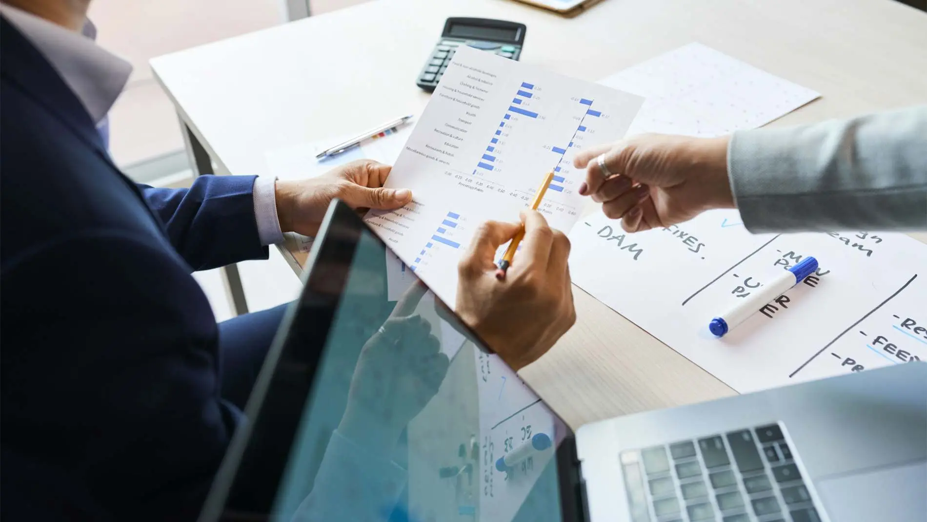 Business people discussing survey results Belinos Consulting compliance London