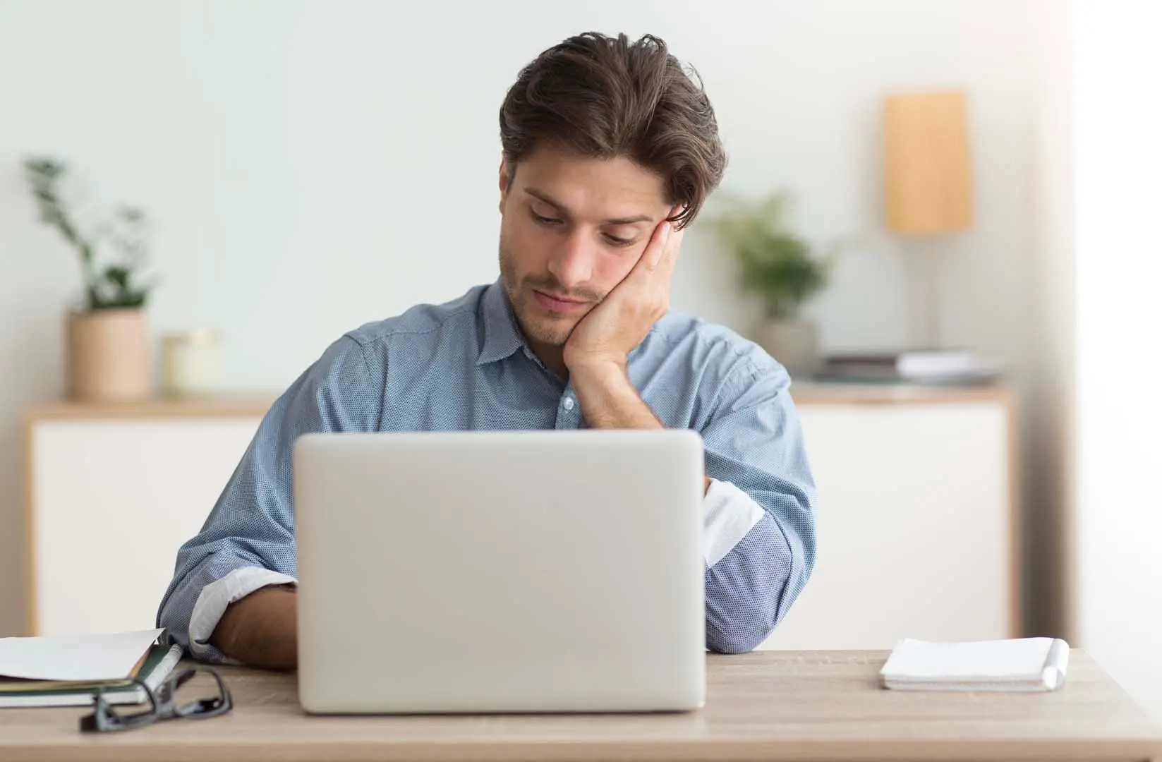 Man reviewing documents at a laptop Belinos Consulting coverholder audits London