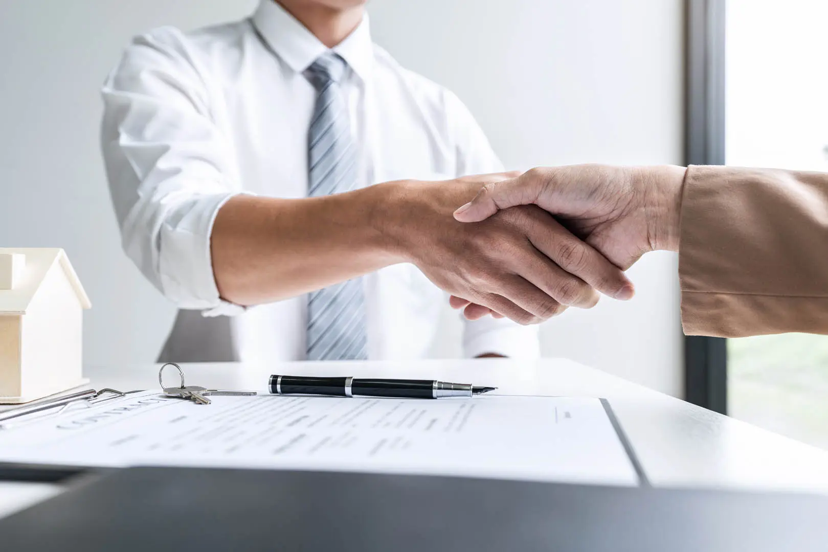 Consultant shaking hands with clients Belinos Consulting regulatory training London