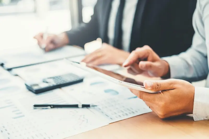 Business team planning with a digital tablet Belinos Consulting London