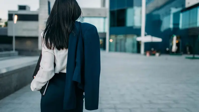 Businesswoman holding a suit jacket Belinos Consulting financial crime review London