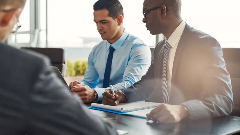 Business executives in a management meeting Belinos Consulting general services London