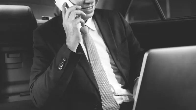 Businessman sitting in a car Belinos Consulting administration services London